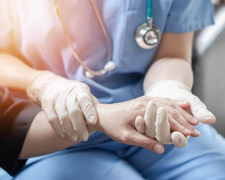 Surgeon, surgical doctor, anesthetist or anesthesiologist holding patient's hand for health care trust and support in professional ER surgical operation, medical anesthetic safety, healthcare concept
